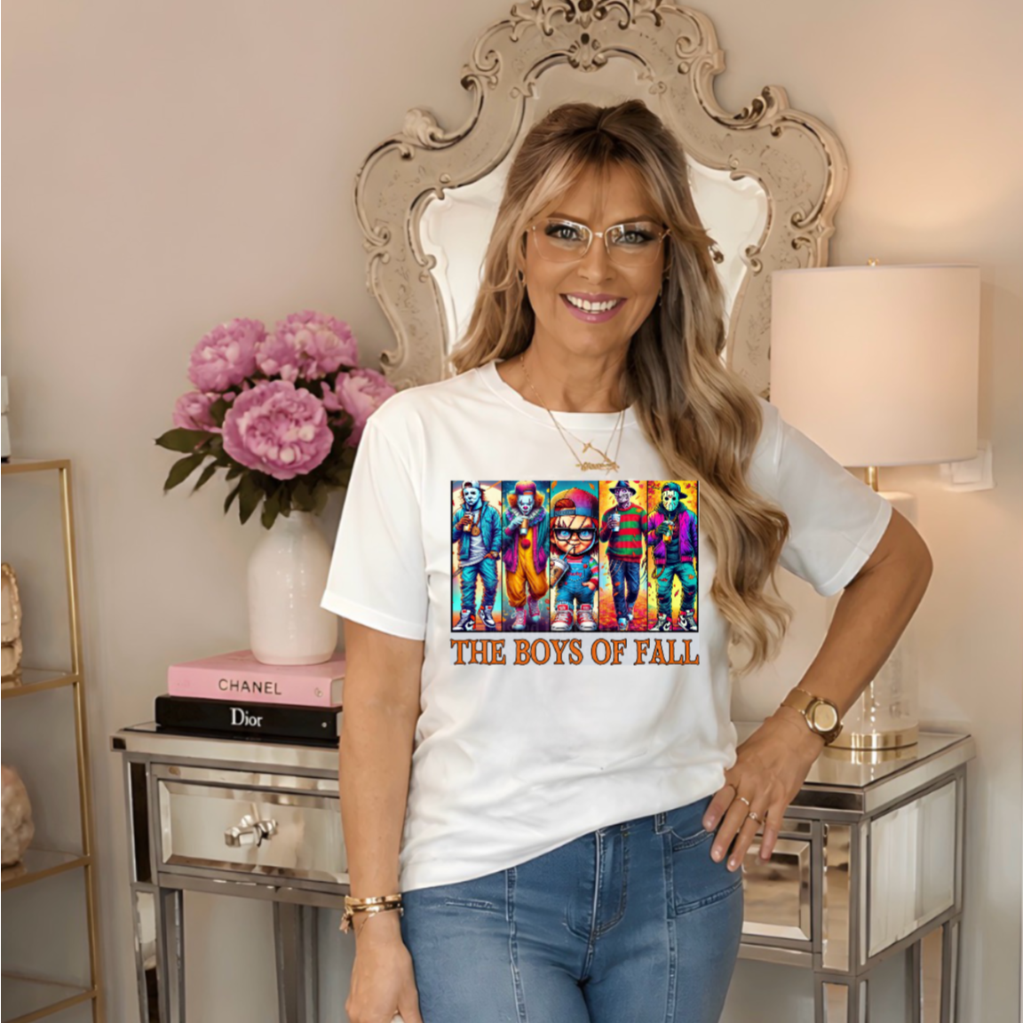 a white graphic T-shirt with a colorful retro band print and the text 'THE BOYS OF FALL,'