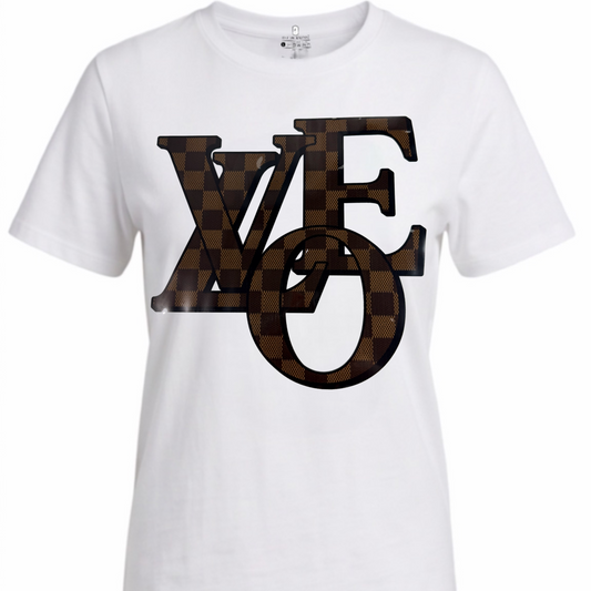 A white short-sleeve crewneck t-shirt featuring a large 'LOVE' graphic on the front. The letters 'V' and 'E' are filled with a brown and black checkerboard pattern, and the 'O' is a matching checkerboard square.