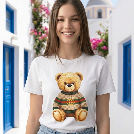 Woman wearing a white t-shirt with a teddy bear graphic in a scenic location