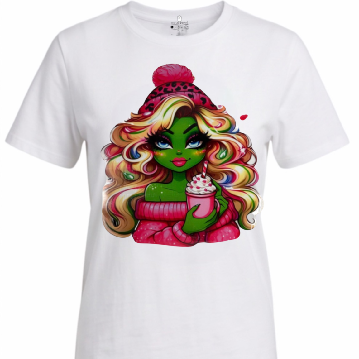 A white short-sleeve crewneck t-shirt featuring a colorful graphic print of a cartoon-style green-skinned woman with long wavy rainbow hair, wearing a pink beanie and holding a drink.