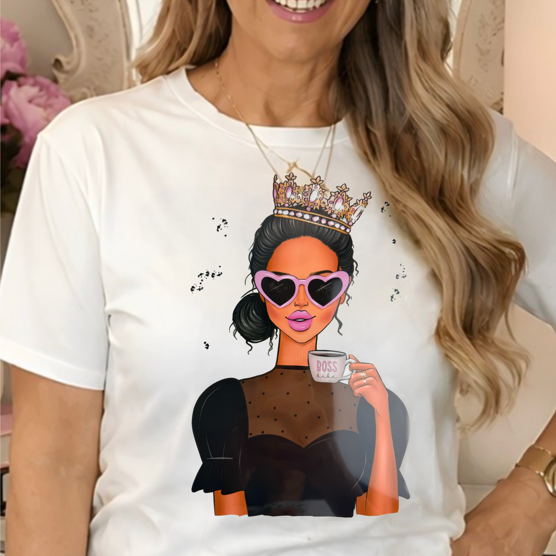 a white graphic t-shirt with a cartoon illustration of a queen holding a cup