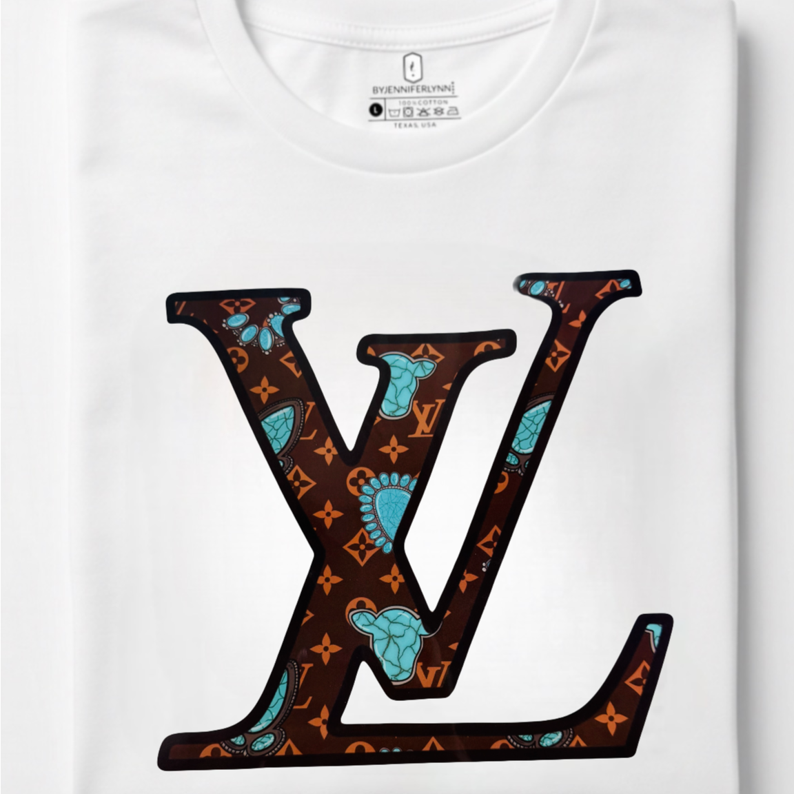 A folded white Louis Vuitton T-shirt with a large LV logo printed on the front in brown, orange, and turquoise, set against a clean white background.