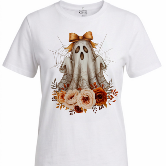 A white short-sleeve crewneck t-shirt featuring a central graphic of a cute cartoon ghost with a brown bow, surrounded by orange and pink roses, spiderwebs, and spider legs.