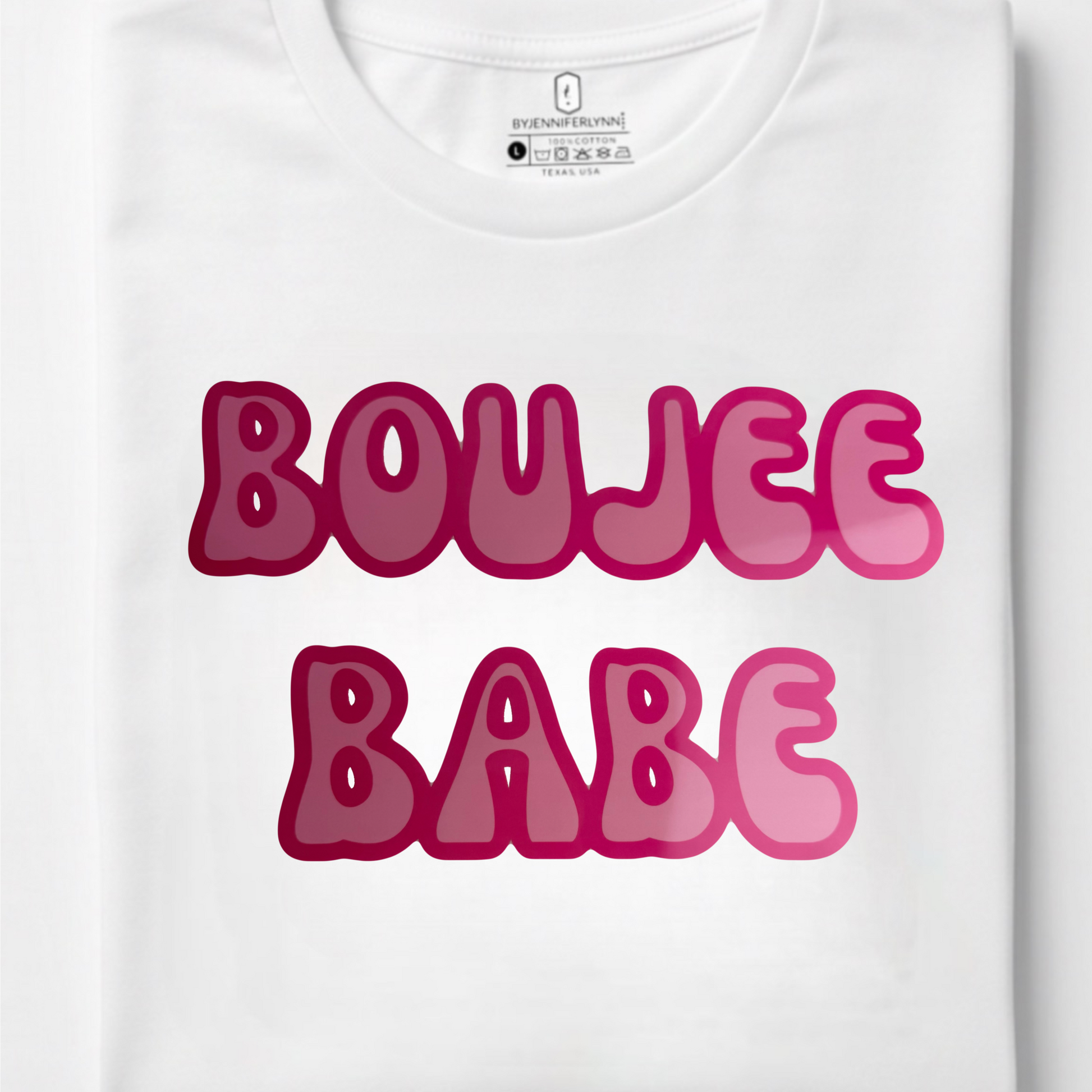 A folded white crewneck t-shirt featuring the words 'BOUJEE BABE' printed in a bold, bubbly pink font with a darker magenta outline, set against a clean white background.